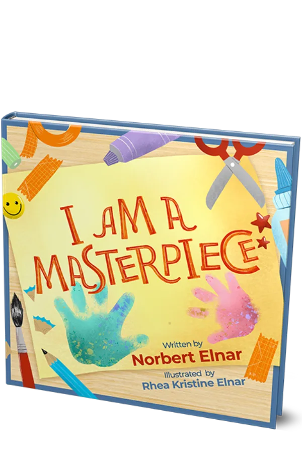 The cover of “I Am a Masterpiece”: two painted handprints on a yellow sheet of paper, surrounded by crayons, scissors and paint.